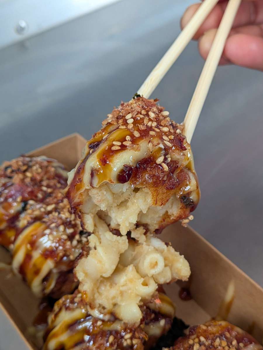 Wokaroni and Cheese held with chopsticks